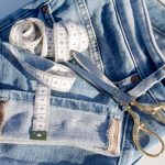depicting a tape measure and a pair of scissorswhich can be used to have tailored denim jeans